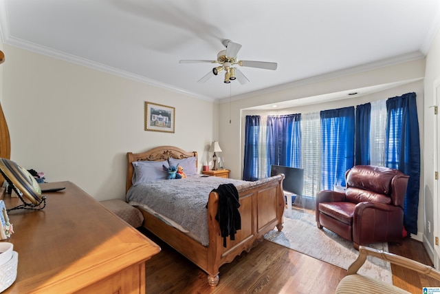 bedroom with dark hardwood / wood-style flooring, ceiling fan, and ornamental molding