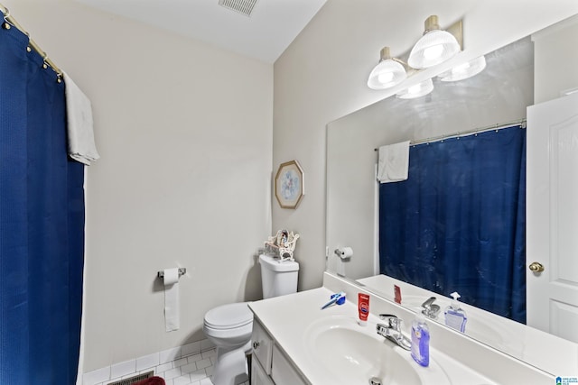 bathroom featuring tile patterned floors, vanity, and toilet