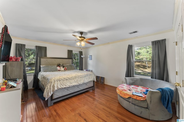 bedroom featuring ceiling fan, dark wood-type flooring, and ornamental molding