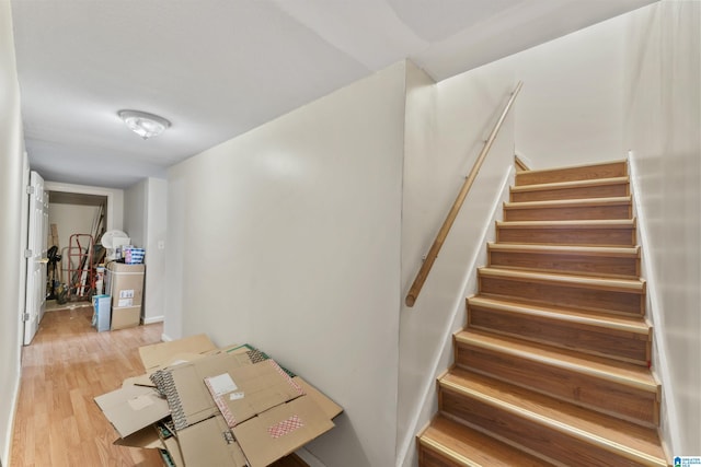 staircase with hardwood / wood-style flooring