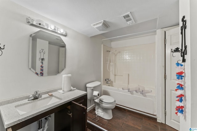 full bathroom featuring hardwood / wood-style flooring, tiled shower / bath combo, toilet, and vanity