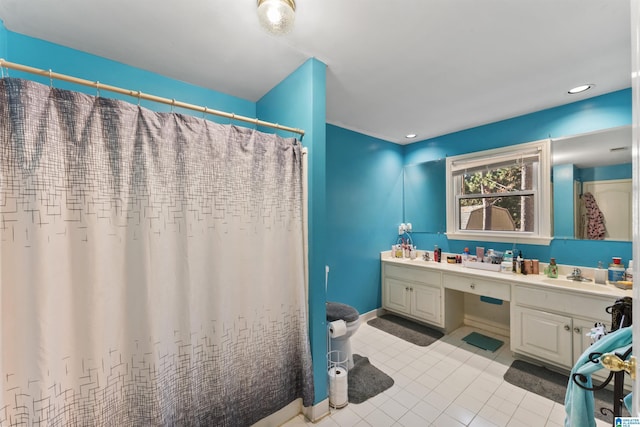 bathroom featuring tile patterned flooring and vanity