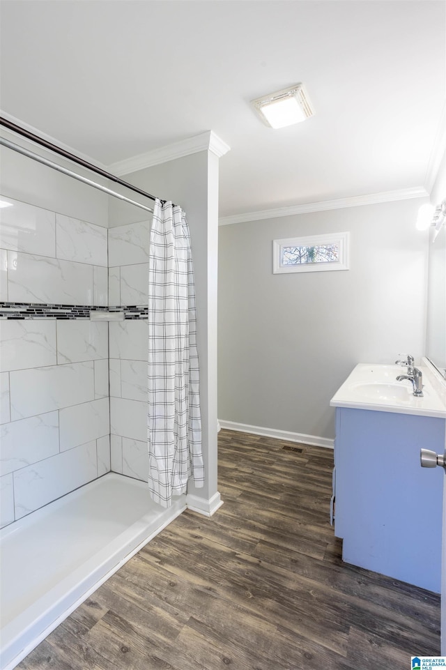 bathroom featuring a shower with shower curtain, vanity, hardwood / wood-style flooring, and crown molding