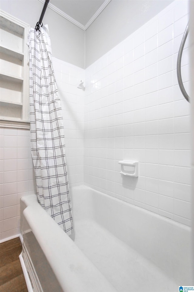 bathroom with hardwood / wood-style floors, ornamental molding, and shower / bath combination with curtain