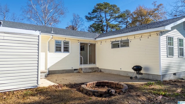 back of house with a fire pit and a patio area