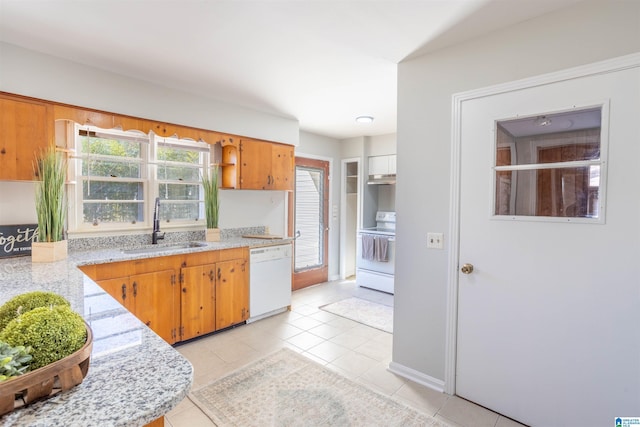 kitchen featuring light stone counters, white appliances, sink, and light tile patterned floors