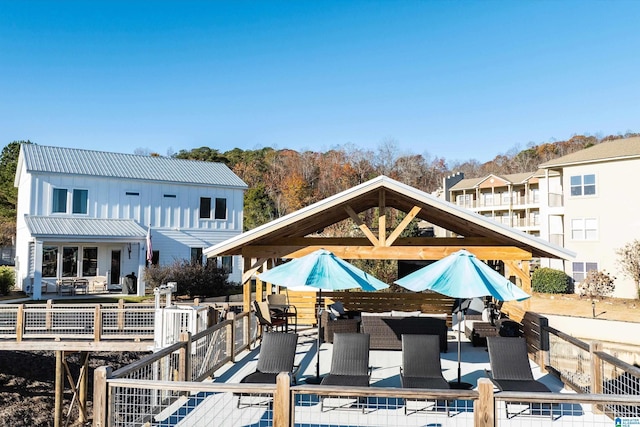 rear view of house with outdoor lounge area and a wooden deck