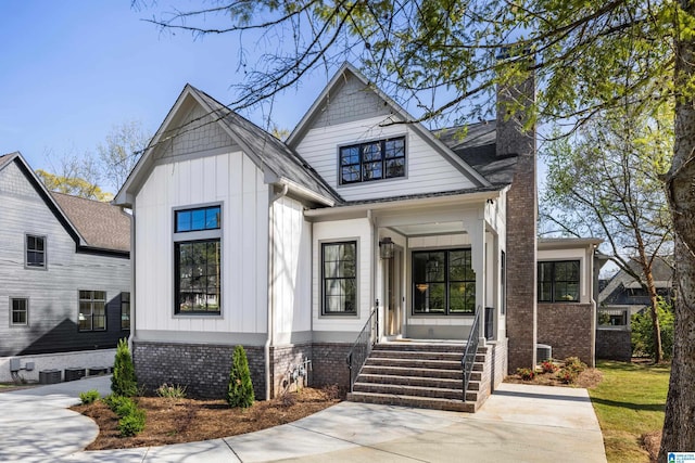721 Euclid Ave, Mountain Brook, AL 35213 - view of front of home with a chimney and board and batten siding