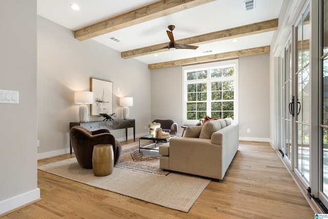 living room featuring beam ceiling, ceiling fan, and light hardwood / wood-style flooring