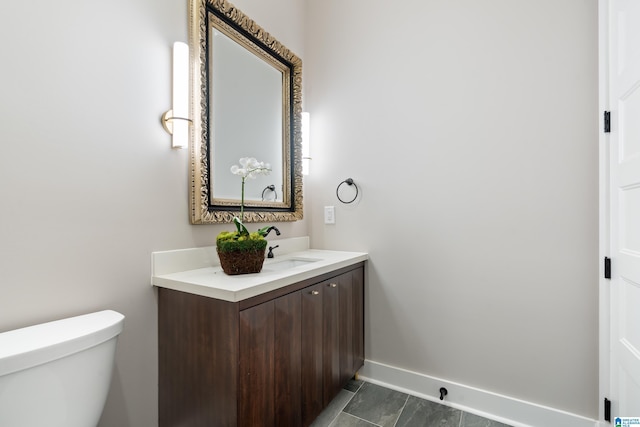 bathroom with tile patterned flooring, vanity, and toilet