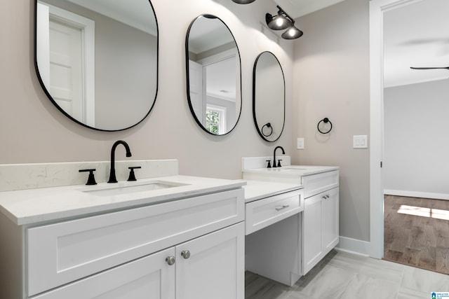 bathroom with vanity, hardwood / wood-style flooring, and ceiling fan