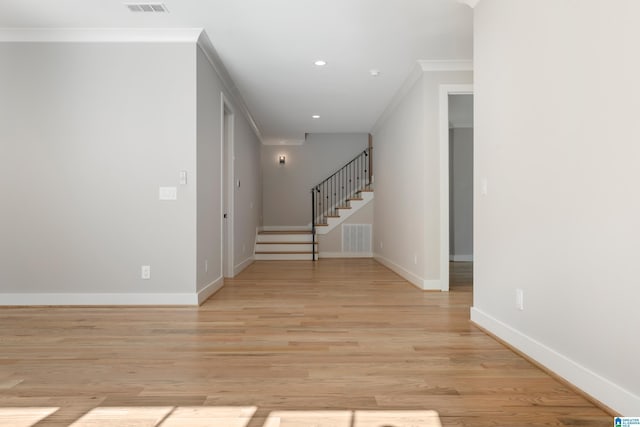 interior space featuring light hardwood / wood-style floors and crown molding