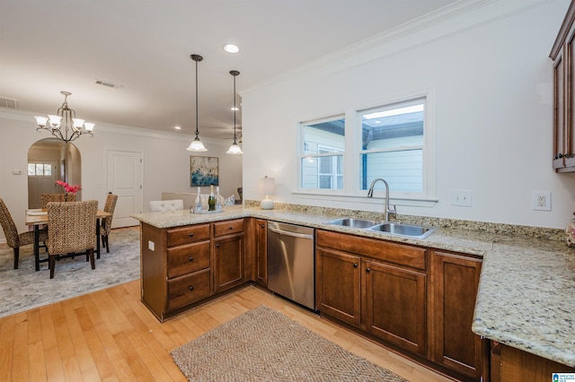 kitchen with stainless steel dishwasher, pendant lighting, light wood-type flooring, and sink