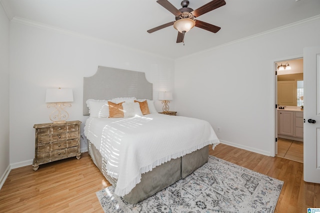 bedroom featuring light wood-type flooring, ensuite bath, ceiling fan, and ornamental molding