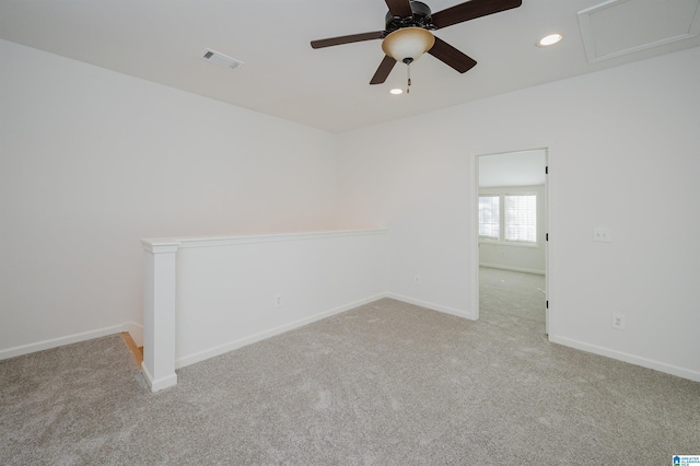 carpeted spare room featuring ceiling fan