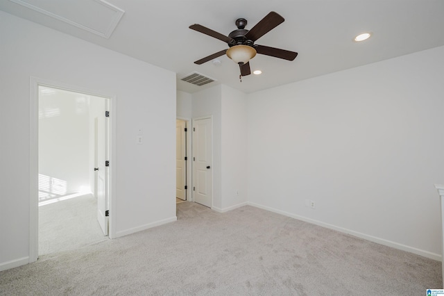 carpeted spare room featuring ceiling fan