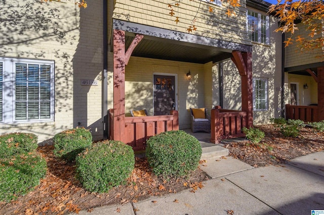 doorway to property featuring covered porch and a balcony