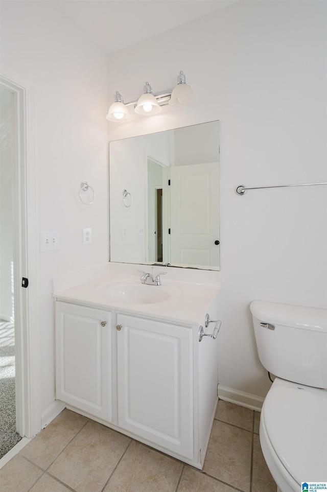 bathroom featuring toilet, vanity, and tile patterned floors