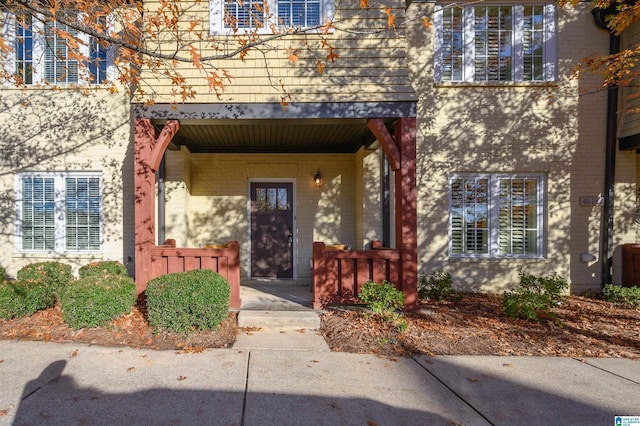 view of exterior entry featuring a balcony