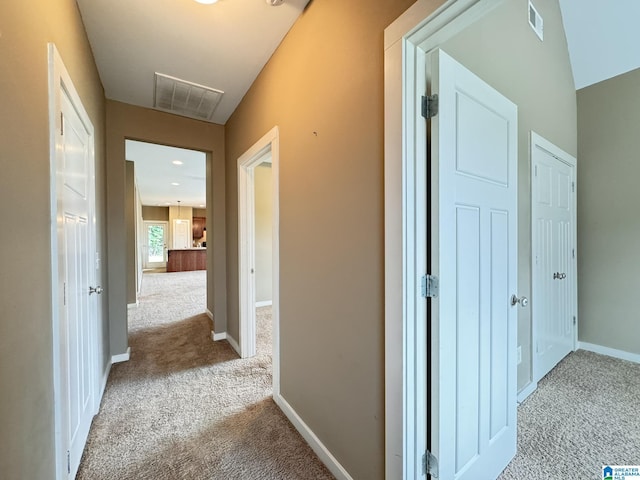 hallway featuring light carpet