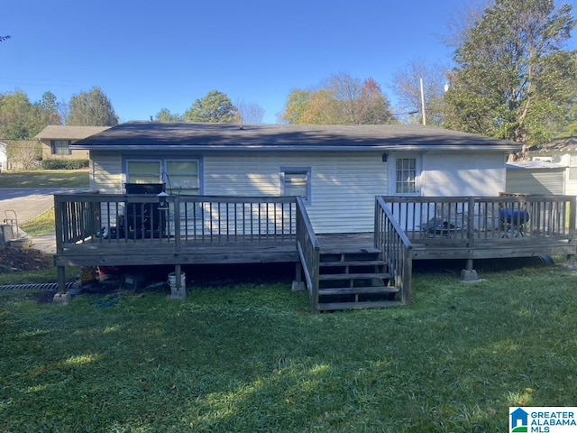 back of property featuring a wooden deck and a yard