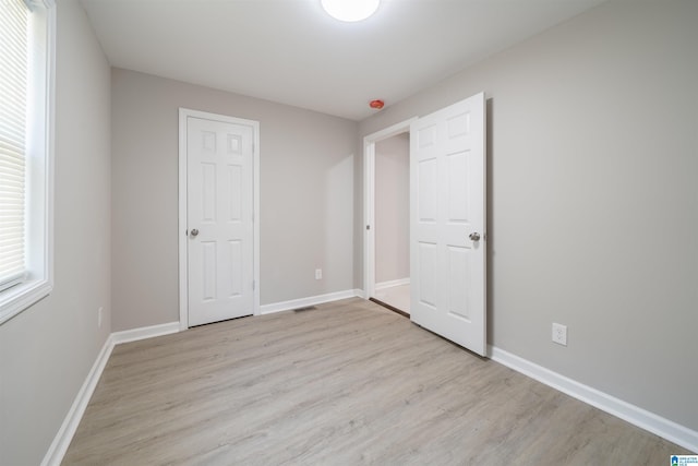 unfurnished bedroom with light wood-type flooring