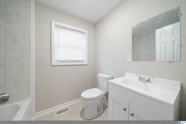 full bathroom featuring tiled shower / bath, tile patterned floors, vanity, and toilet