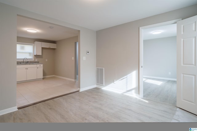 interior space featuring sink and light wood-type flooring