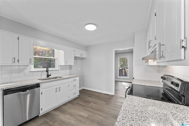 kitchen with sink, tasteful backsplash, dark hardwood / wood-style flooring, white cabinetry, and stainless steel appliances