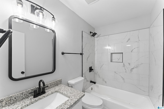 full bathroom featuring toilet, vanity, and tiled shower / bath