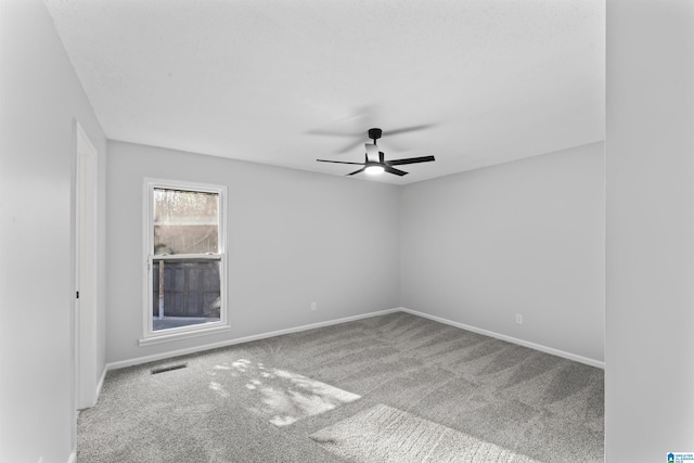 spare room featuring carpet flooring and ceiling fan