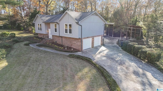 view of side of home with a garage and a lawn