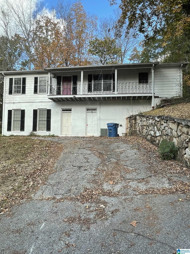 view of front of house with a balcony and central AC unit