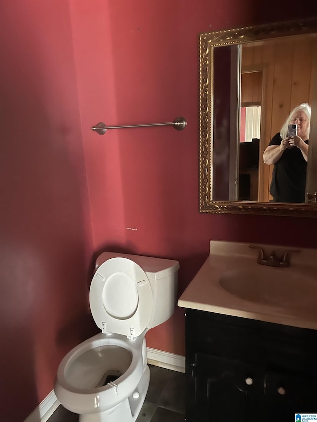 bathroom with tile patterned flooring, vanity, and toilet