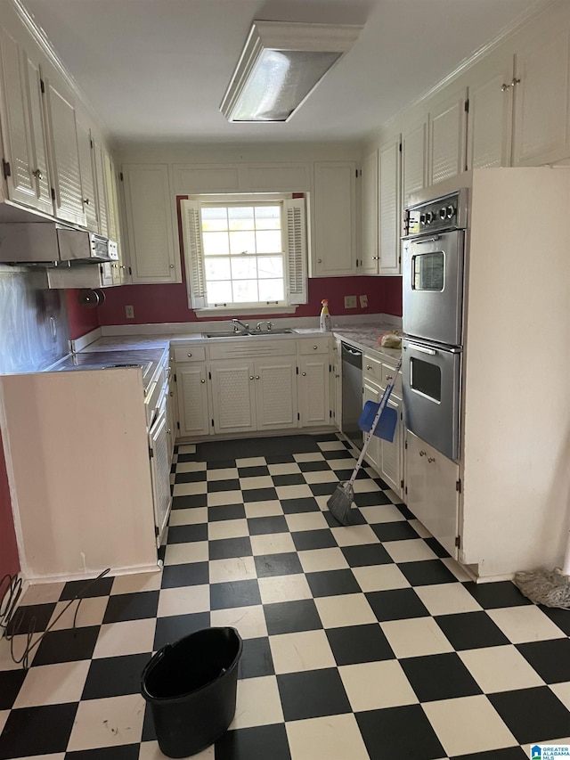 kitchen featuring white cabinets, stainless steel appliances, and sink