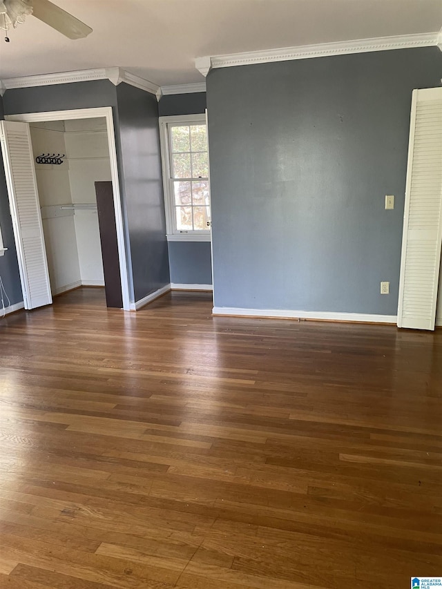 unfurnished bedroom featuring ceiling fan, dark hardwood / wood-style flooring, and crown molding