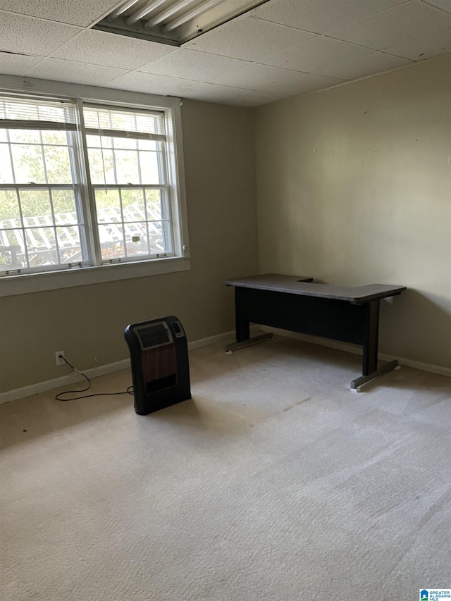 interior space with light carpet and a paneled ceiling