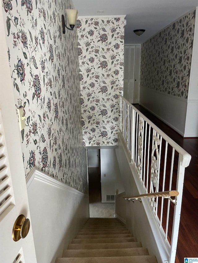 staircase with hardwood / wood-style floors