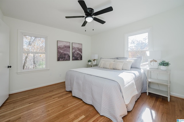 bedroom with ceiling fan and hardwood / wood-style flooring