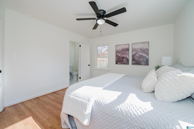 bedroom with ceiling fan, light wood-type flooring, and ensuite bath