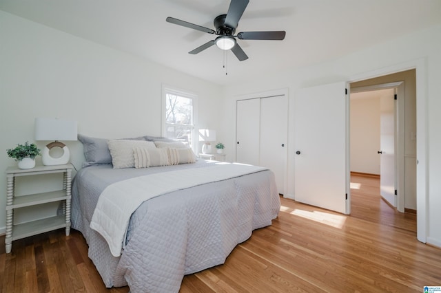 bedroom featuring hardwood / wood-style floors, a closet, and ceiling fan