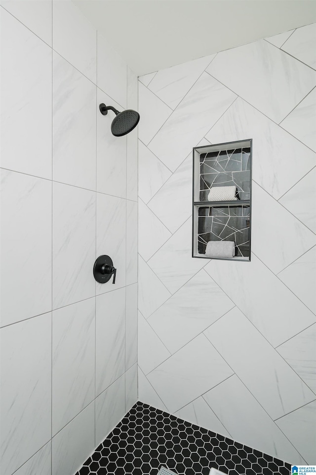 bathroom with tiled shower