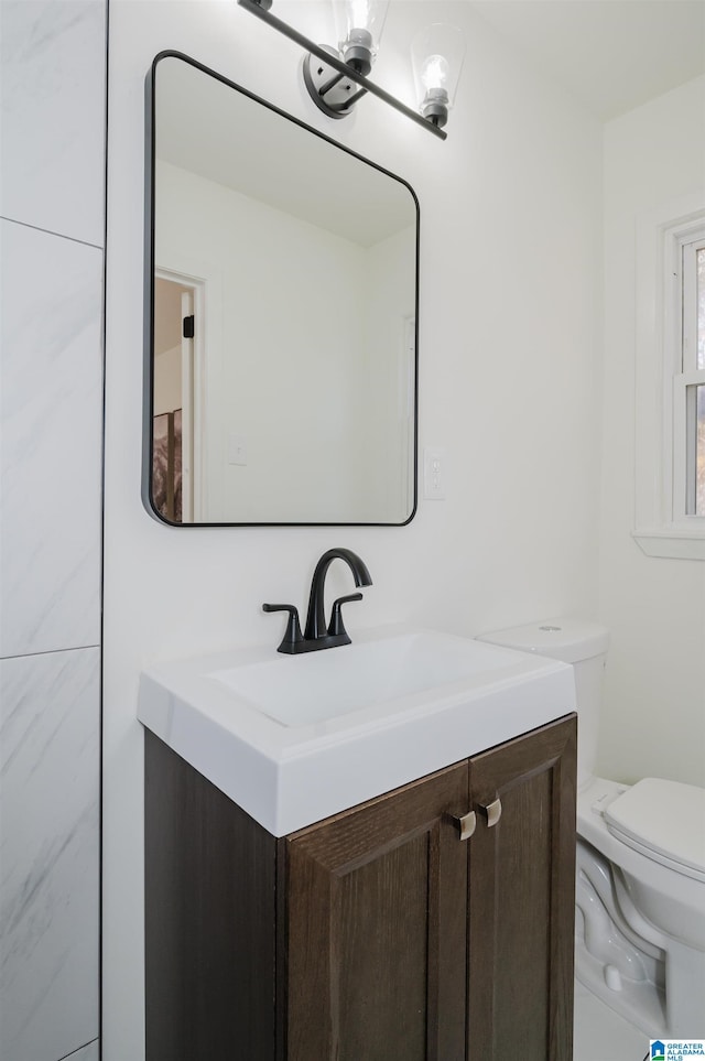 bathroom featuring vanity and toilet