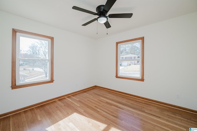 spare room featuring light hardwood / wood-style flooring and ceiling fan