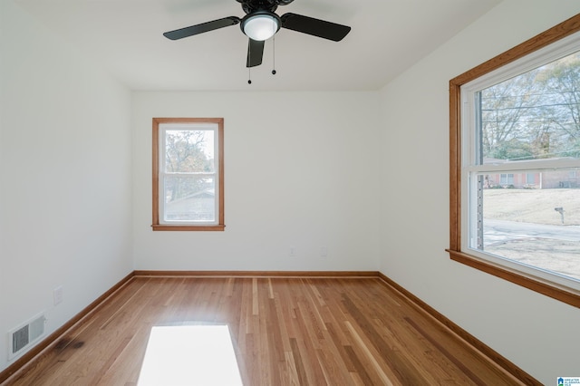 spare room with ceiling fan, light hardwood / wood-style flooring, and a healthy amount of sunlight