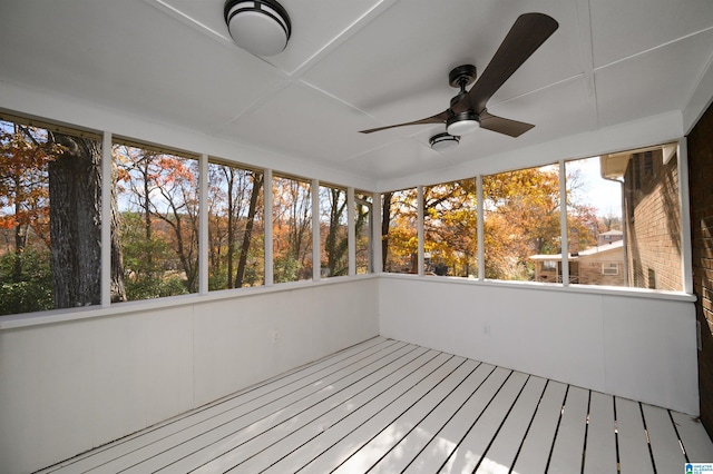 unfurnished sunroom featuring ceiling fan