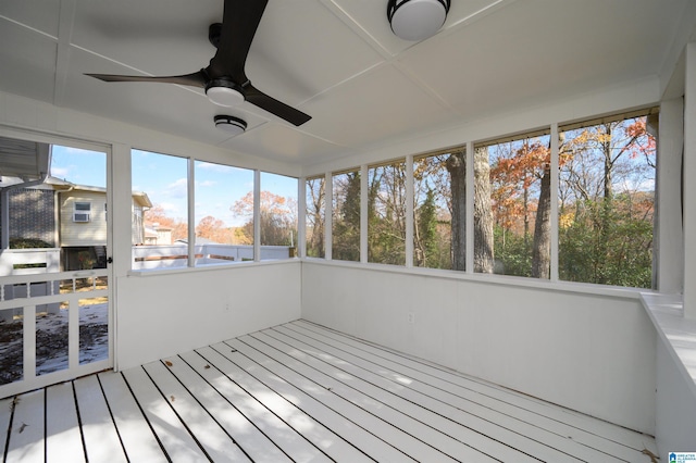 unfurnished sunroom featuring ceiling fan and a wealth of natural light