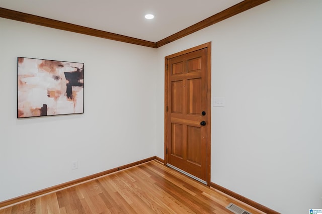 spare room with light hardwood / wood-style flooring and ornamental molding