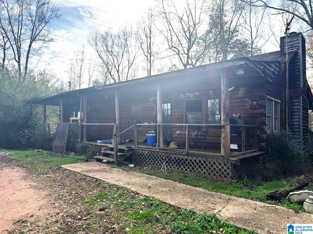 rear view of property featuring a porch