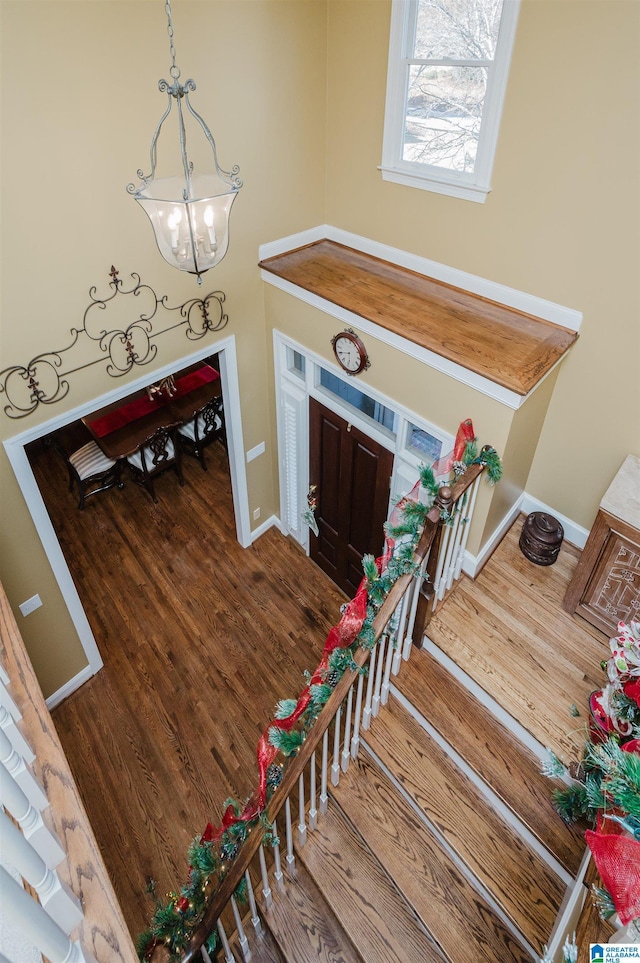 foyer with wood-type flooring and a chandelier